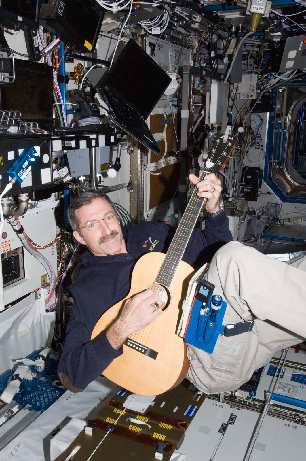 Burbank plays a guitar in the U.S. Laboratory