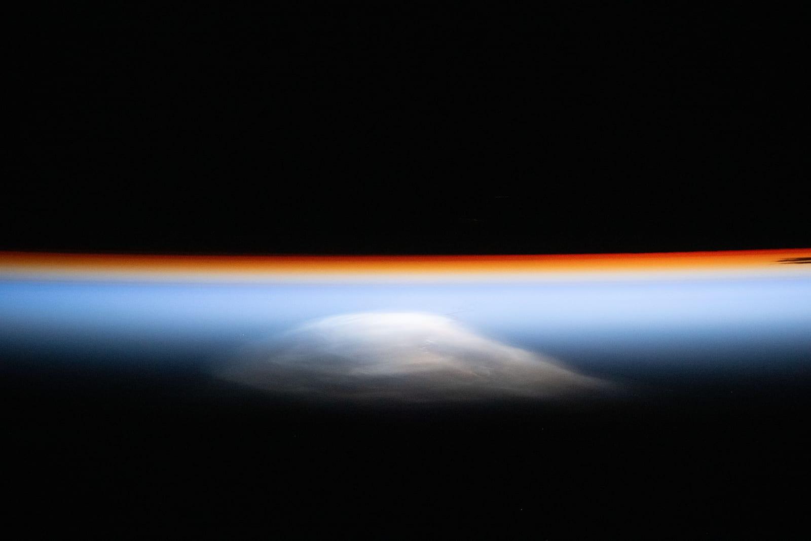 The last rays of an orbital sunset outline Earth’s horizon