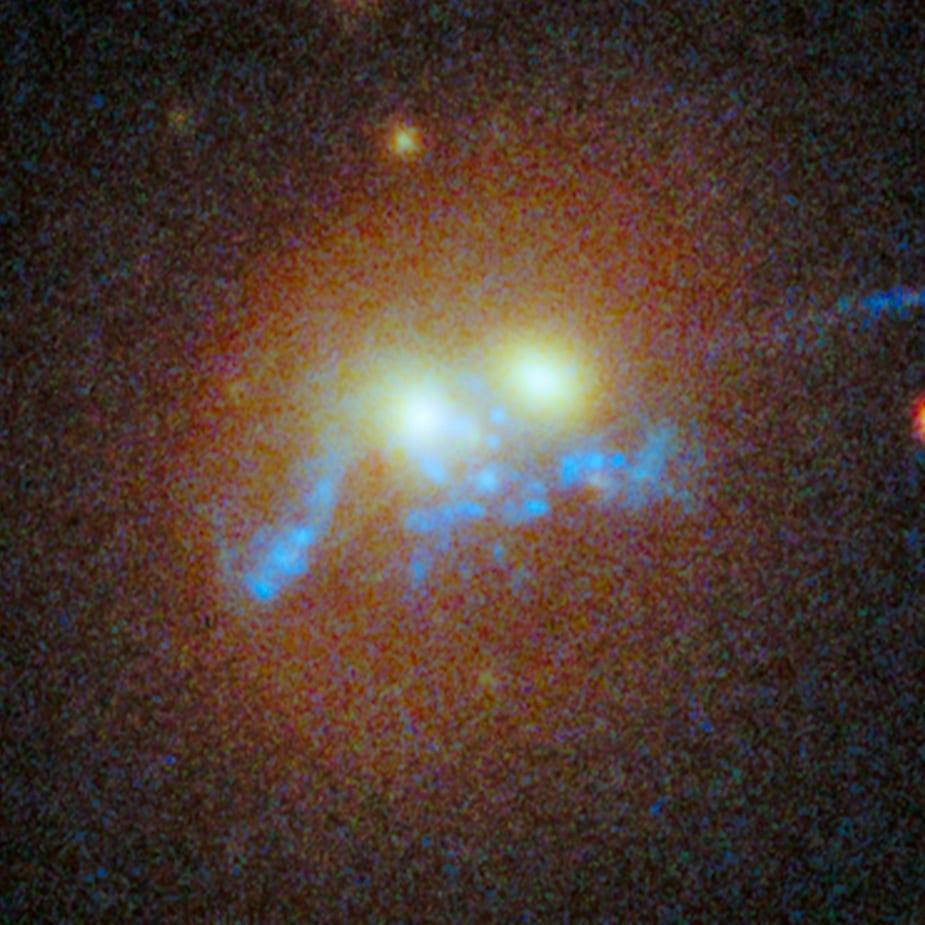 Hubble Sees Spiral Bridge of Young Stars Between Two Ancient Galaxies